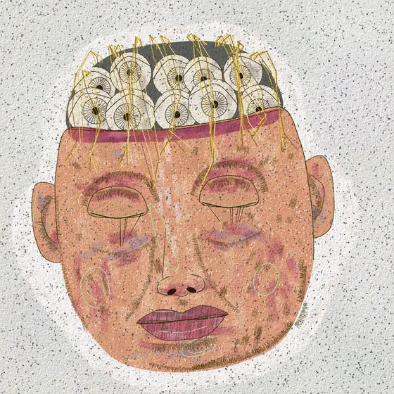 A big calm face with a row of small rings across the forehead