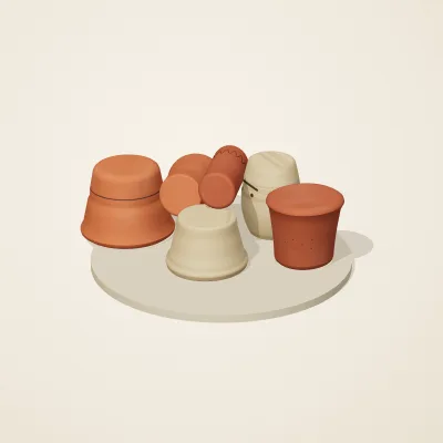 The six parts of Etruscan Terracotta No. 23 in a loose pile on a round stand