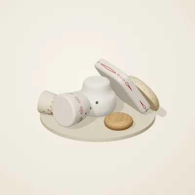 The six parts of Slavic Folk Toys No. 2 in a loose pile on a round stand