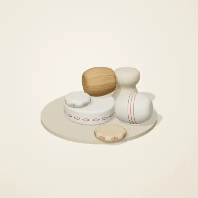 The six parts of Slavic Folk Toys No. 3 in a loose pile on a round stand