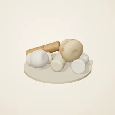 The six parts of Slavic Folk Toys No. 17 in a loose pile on a round stand