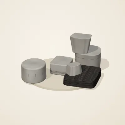 The six parts of Ashen Relics No. 21 in a loose pile on a round stand